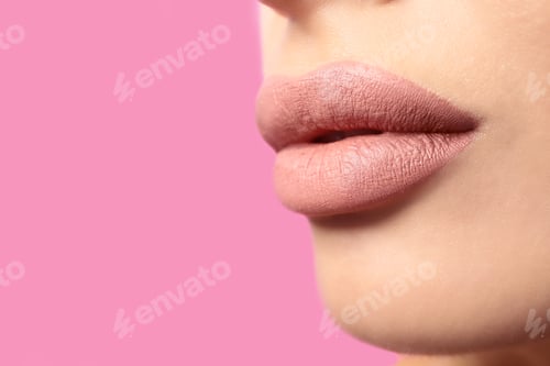 Preview: Woman with matte lipstick on pink background, closeup. Space for text
