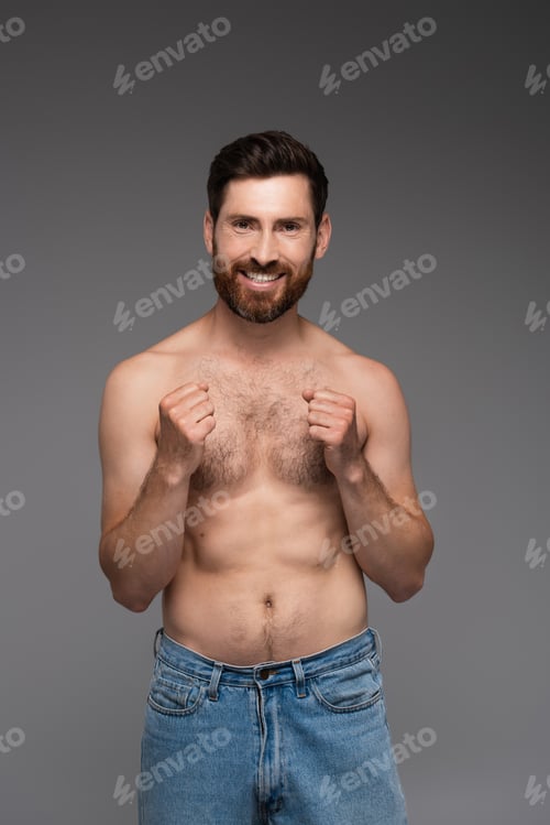 Preview: shirtless and cheerful man with hair on chest smiling isolated on grey