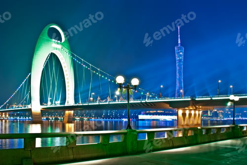 Illuminated Bridge and City Skyline at Night