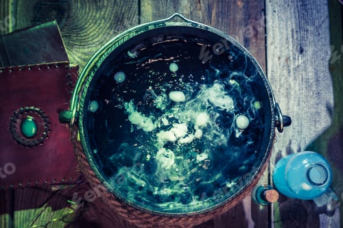 Preview: Closeup of witcher cauldron with books for Halloween