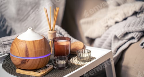 Preview: A cozy composition with an aroma diffuser and candles in a home interior.
