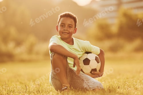 Preview: Beautiful sunshine. African american kid have fun in the field at summer daytime