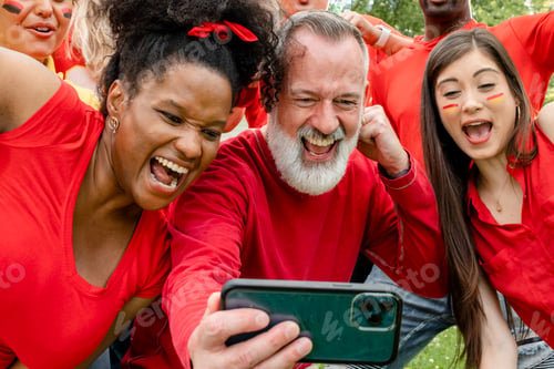 Preview: Supporters watching their team win the game on a mobile phone