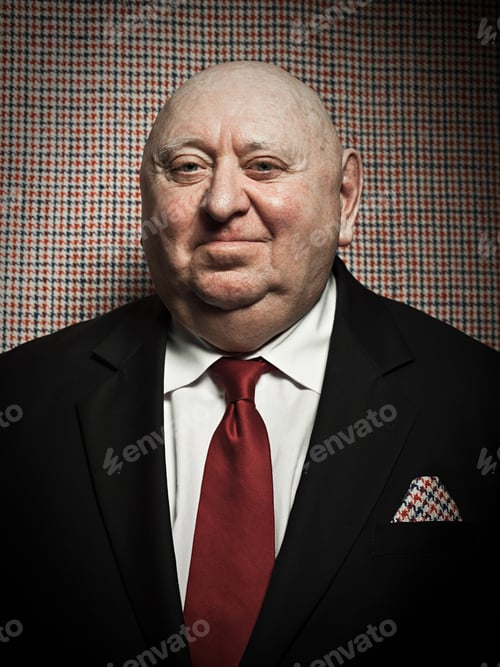 Preview: Senior man against dogtooth check background, with matching handkerchief