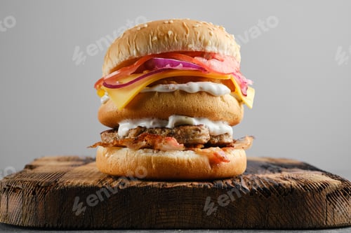 Preview: Monster double burger on wooden board, front view
