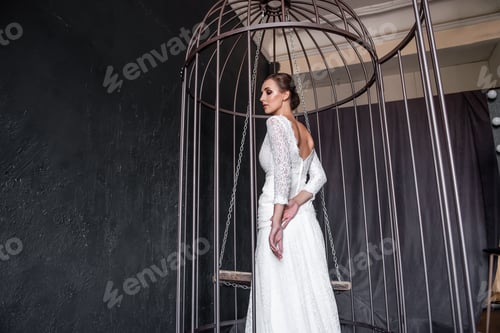 Preview: Woman in White Dress Inside Metal Birdcage