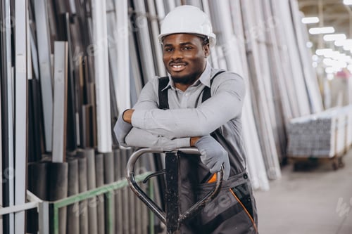 Preview: Factory worker leaning on pallet jack in warehouse with pvc windows and doors