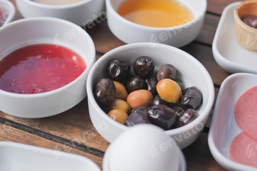 Preview: Collection of black and green olives with leaves.