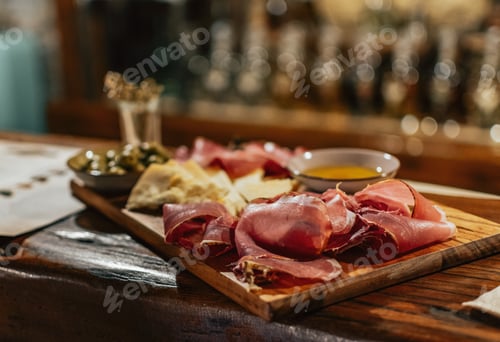 Preview: Charcuterie board with cured pork meat, sauce, bread and olive