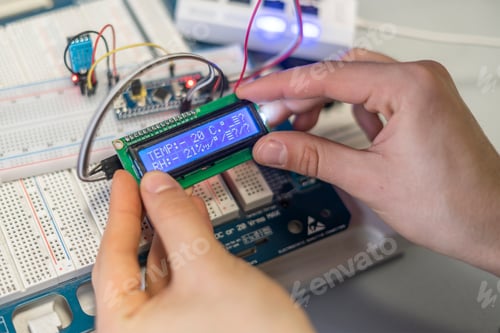 Preview: persons hands attach or install electric silicon chip or sensor b