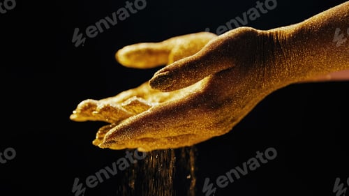 Preview: Golden glittering woman hands with dust, sand on black background. Life moments.