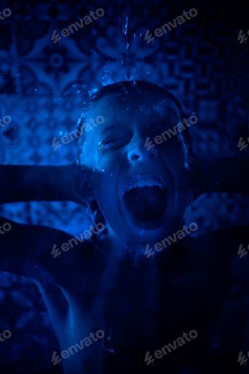 Preview: Shirtless boy shouting in shower room in blue light
