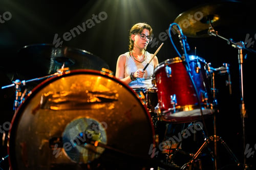 Preview: Female drummer performing live on stage with drum kit