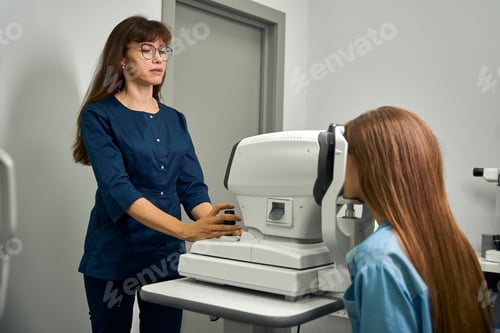 Preview: Adult optometrist preparing patient for eye examination
