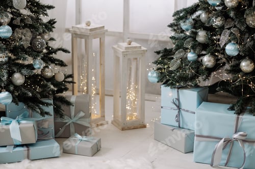 Preview: Christmas trees with blue and silver ornaments and gift boxes on white wooden floor