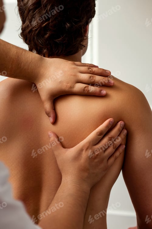 Preview: Man Receiving Shoulder and Back Medical Massage Therapy Indoors