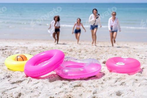 Preview: Teenage girl friendship enjoy laughing play on the blue sky sea and run to get water inflation toy