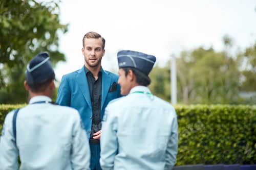 Preview: Young handsome businessman talking with the doormen