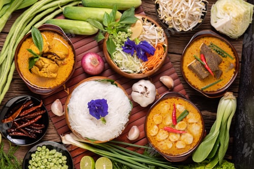 Preview: Rice noodles in a bowl of curry paste with chili, cucumber, long bean, lime, garlic and spring onion