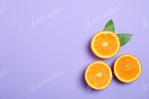 Preview: Flat lay composition with oranges and leaves on color background. Space for text
