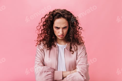 Preview: Young Woman in pink jacket sulking on isolated background