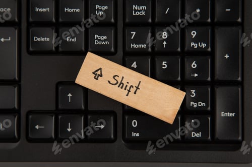 Preview: top view shift icon on wood block on keyboard on wooden table