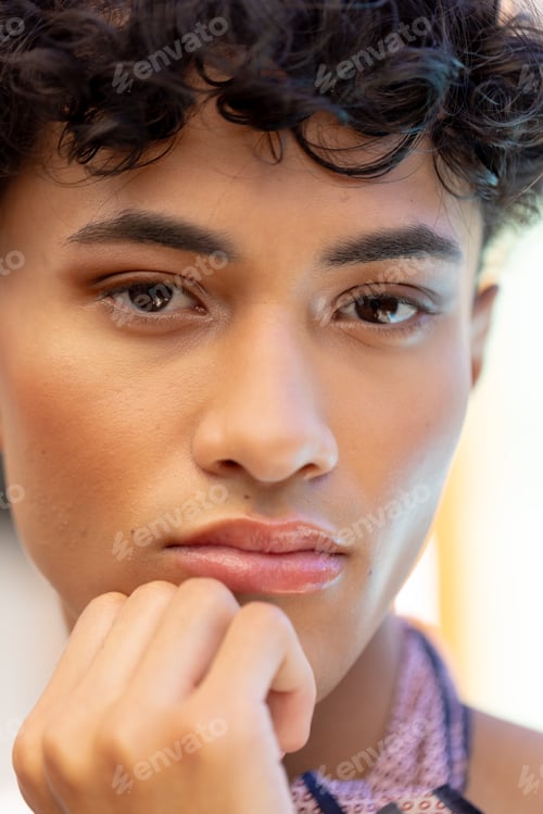 Preview: Close-up of transgender transgender woman resting chin on hand, looking thoughtful