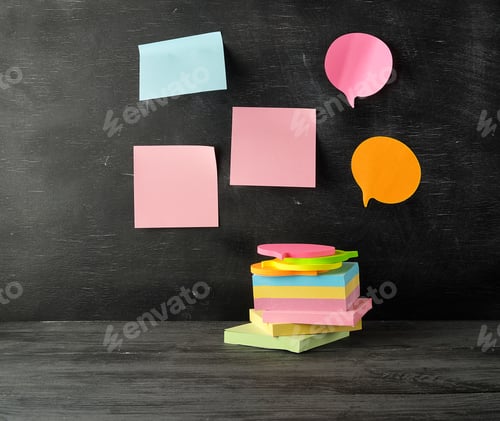 Preview: Stack of multi-colored sticky stickers on a black wooden background