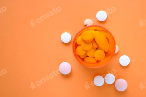 Preview: white pills and orange container on color background