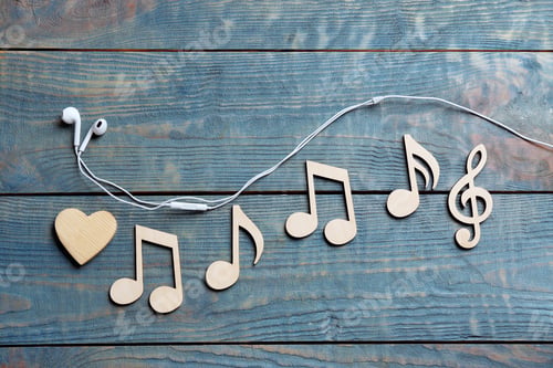 Preview: Flat lay composition with music notes and earphones on wooden background