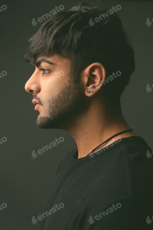 Preview: Young handsome Indian man against gray background