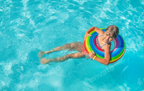 Preview: the child swims and dives in the pool. Selective focus.