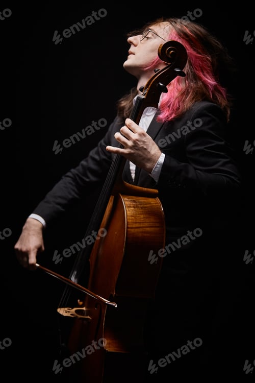 Preview: Charismatic Musician in Black Suit Playing Violoncello