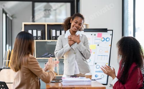 Preview: A group of young American businesswomen pointed to a whiteboard to provide information and a portfol