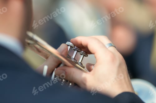Preview: Details of hands playing the trumpet