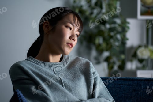 Preview: A woman thinking in a dark room