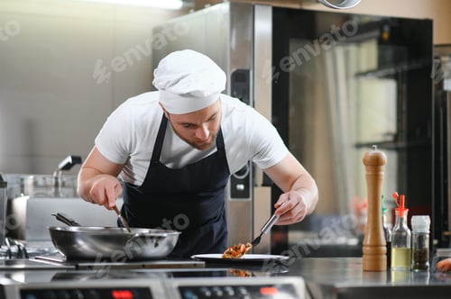 Preview: Chef of a Big Restaurant Prepares Dishes. Modern Kitchen is Made of Stainless Steel