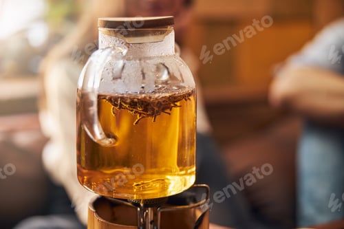 Preview: Glass teapot with herbal tea on portable gas burner