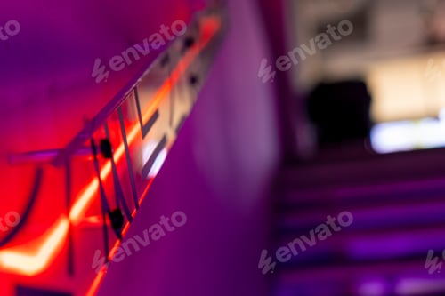 Preview: the interior of a Korean establishment, stairs in neon color in the restaurant