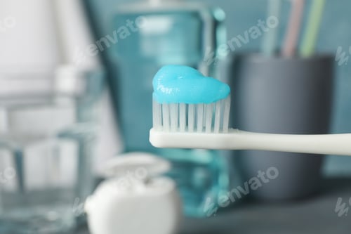 Preview: Toothbrush with toothpaste on background with dental care tools, close up