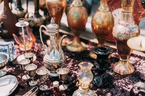 Preview: Metal Oriental Jug With Engraved Texture Floral Pattern. Oriental Style Ancient Jug At Flea Market