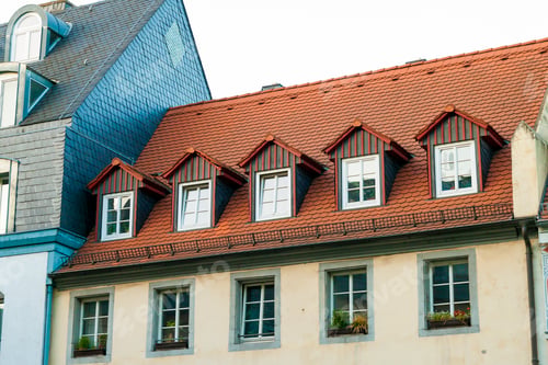 Preview: Roofs of old houses with roof windows and orange roof tiles in German city