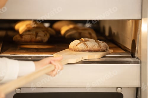 Preview: Baking bread in the oven in bakery.