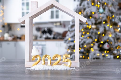 Preview: Golden number 2025, key and tiny home on background of cozy white kitchen with Christmas tree
