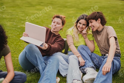 Preview: Young students having fun together taking a selfie with digital tablet
