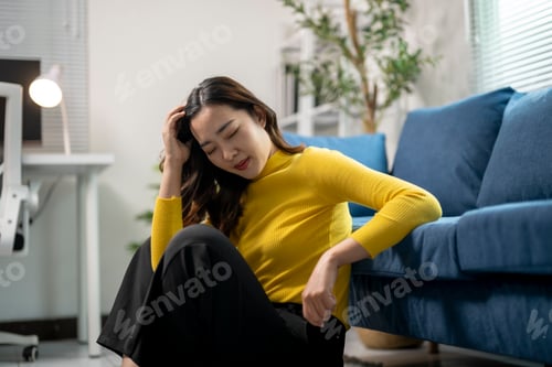 Preview: Young businesswoman is suffering from a headache while working from home