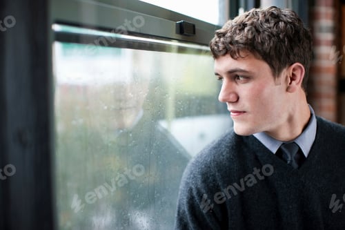 Preview: Businessman looking out window