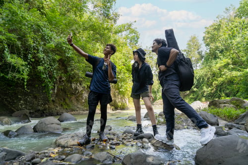Preview: group of young asian men and woman take selfie photo together while trekking in the nature