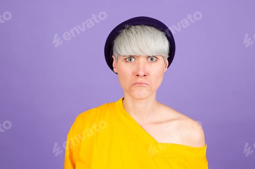 Preview: Stylish european woman on purple background sad upset unhappy emotions