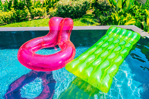 Preview: Colorful swim ring or rubber float around swimming pool water
